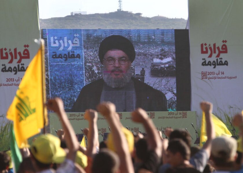Hezbollah supporters watch a televised address by their leader, Hassan Nasrallah, at a rally in south Lebanon, near the Israeli border.