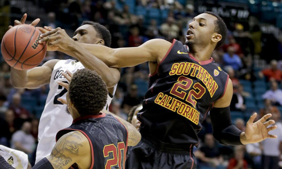 USC's Byron Wesley, right, gets his hand on a shot by Colorado's John Hopkins during the Trojans' season-ending loss in the Pac-12 tournament. Wesley plans to graduate from USC this summer and use his final season of eligibility at another school.