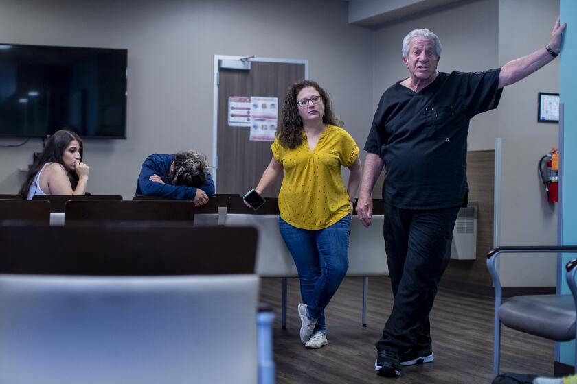 SAN ANTONIO, TX- JUNE 24, 2022: Dr Alan Braid, right, informs patients inside the waiting room that he can no longer provide abortion services since the Supreme Court had just overturned Roe v. Wade shutting down abortion services at Alamo Women's Reproductive Services on June 24, 2022 in San Antonio, Texas. The clinic had to turn patients away once the ruling came down.(Gina Ferazzi / Los Angeles Times)