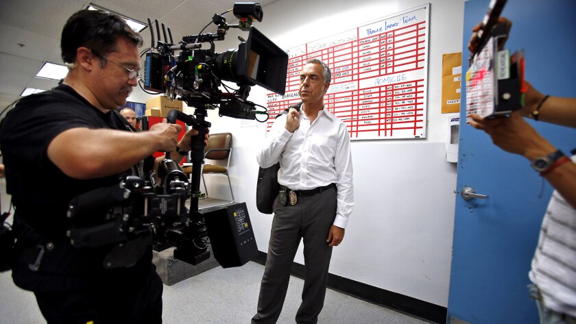 Camera operator Kenji Luster, left, and actor Titus Welliver, who plays Det. Harry Bosch, work on set in Hollywood for the series "Bosch" from Amazon Studios.