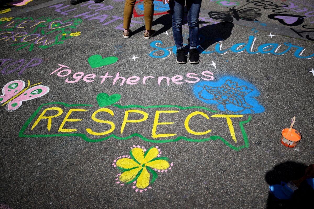 Painted messages on the ground supporting the Asian community.
