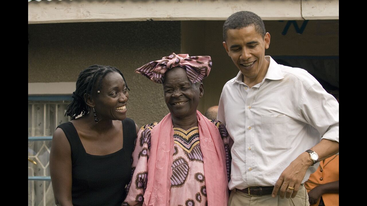 U.S. Sen. Barack Obama (D-Ill.) talks to the press while standing with his sister, Auma Obama, and his step grandmother, Sarah Hussein Obama, outside her house in his family's village of Kogelo, Kenya on Aug. 26, 2006.