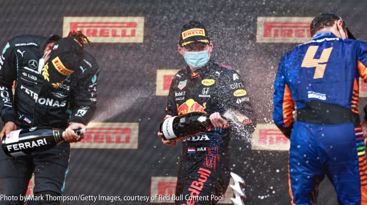Victorious Max Verstappen celebrates on the F1 podium in Imola