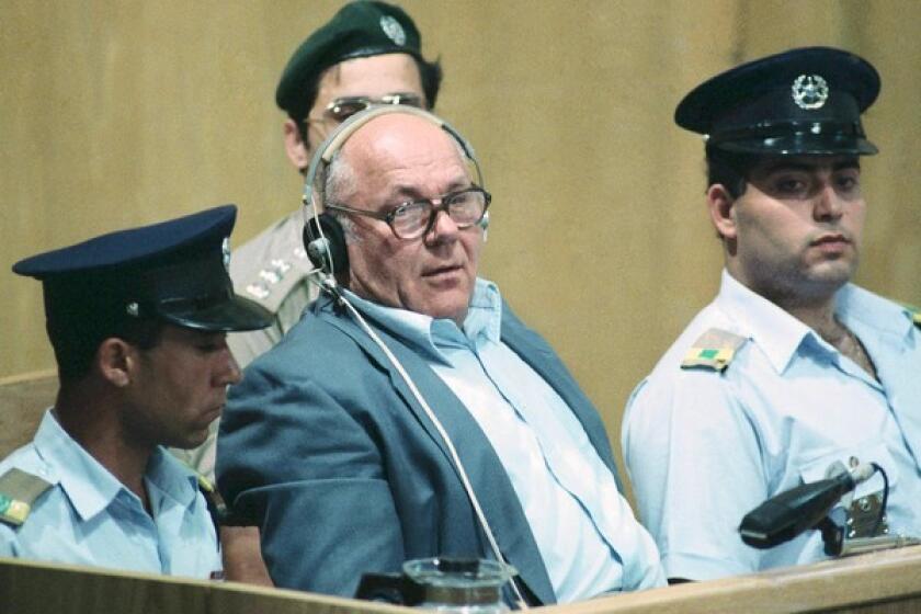 John Demjanjuk, accused of war crimes against humanity, sits in the dock of Israel's supreme court in Jerusalem while being sentenced in April 1988.