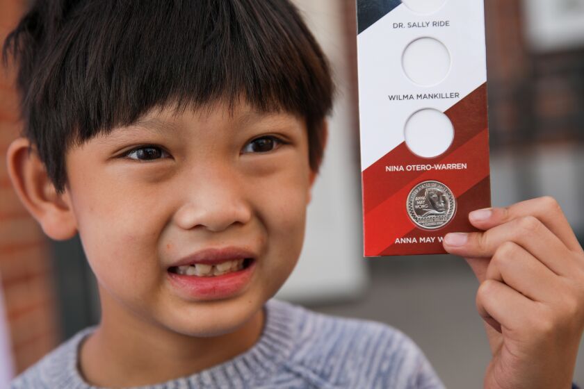 Los Angeles, CA - November 05: Isaac Lin, 6, holds Anna May Wong Quarter he received in a competition held during a celebration at Chinese American Museum on Saturday, Nov. 5, 2022 in Los Angeles, CA. (Irfan Khan / Los Angeles Times)