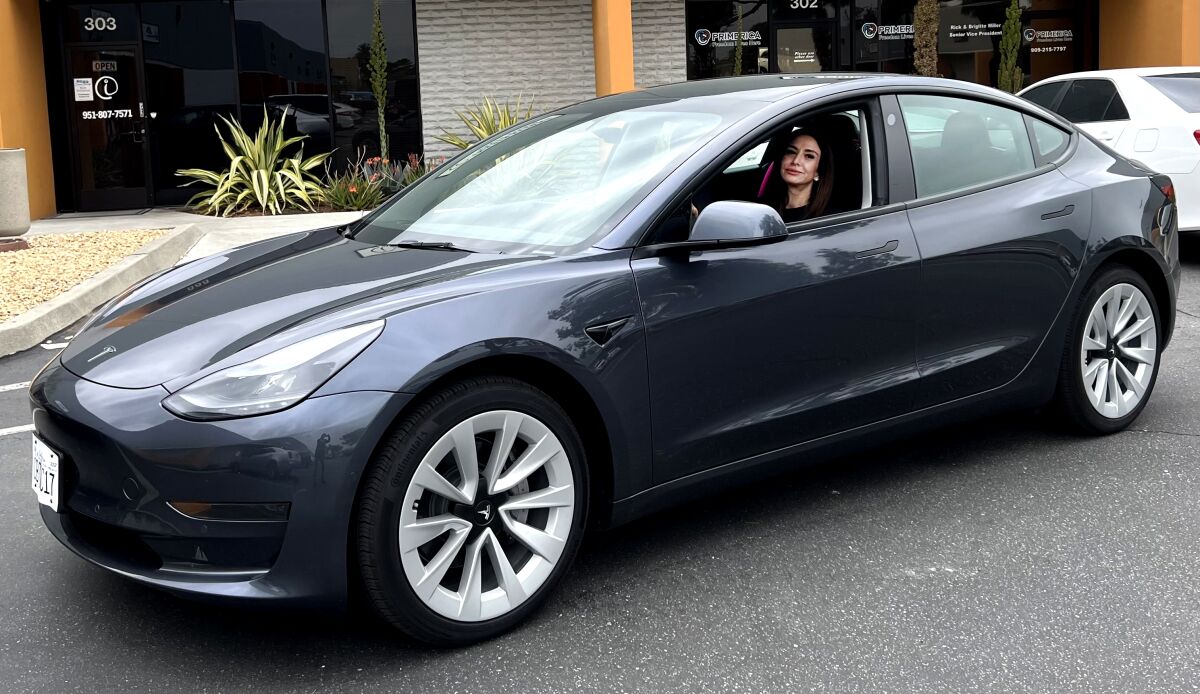 Bonnie Velasquez picks up her new Tesla Model 3 in Santa Monica.