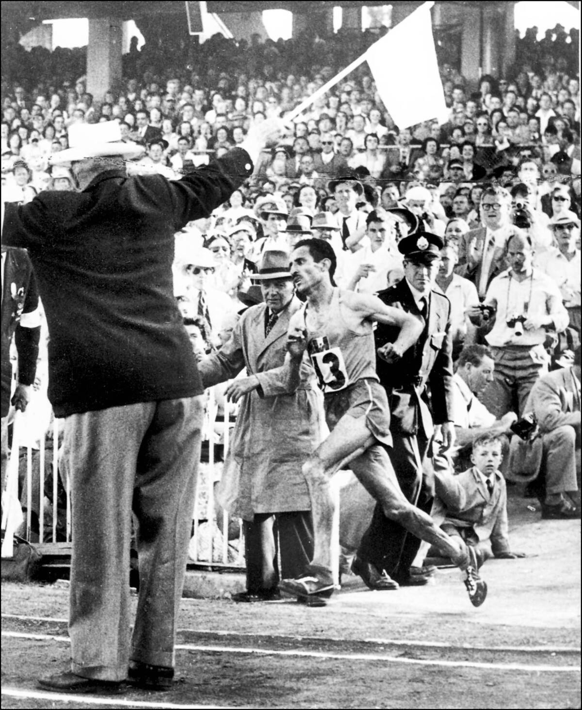 French champion Alain Mimoun, center, runs for the gold in the 1956 Olympics marathon.