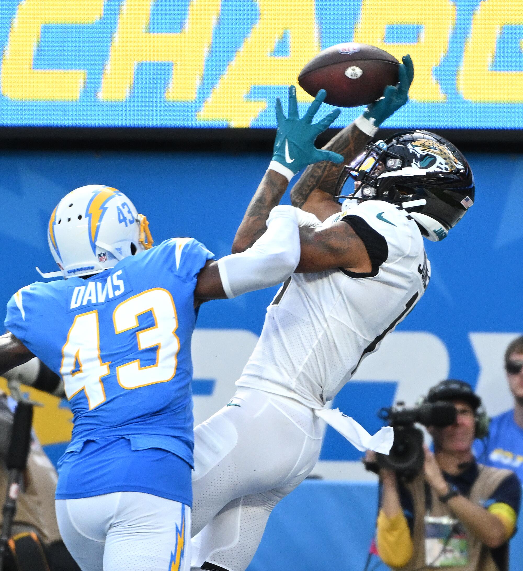 Jaguars receiver Marvin Jones Jr. catches a touchdown pass in front of Chargers cornerback Michael Davis.