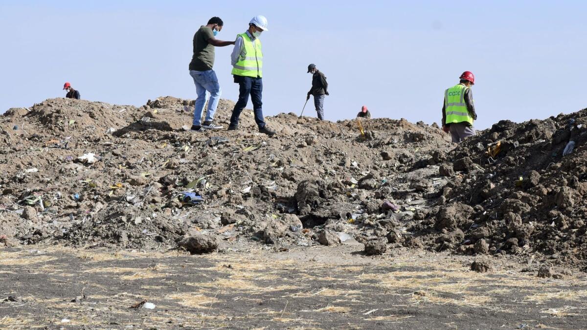 Rescue workers search the site for pieces of the wreckage of an Ethiopia Airlines Boeing 737 Max 8 aircraft near Bishoftu, Ethiopia, on March 13.