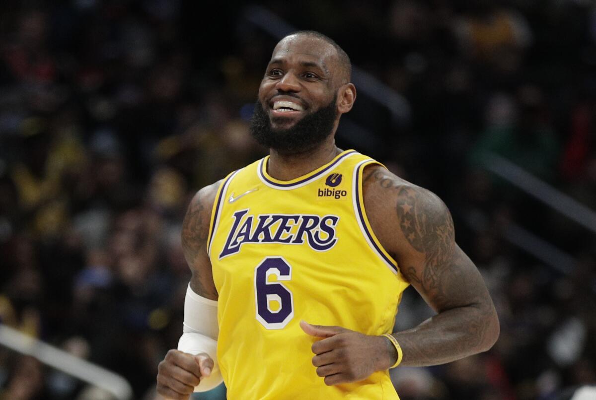 Los Angeles Lakers' LeBron James smiles during the second half of an NBA basketball game against the Washington Wizards