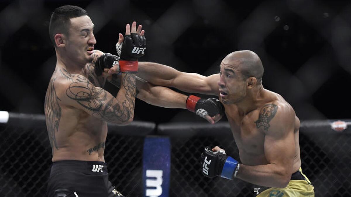 Jose Aldo lands a shot against Max Holloway during the featherweight title fight. See more images fro at UFC 218. click on photo above.