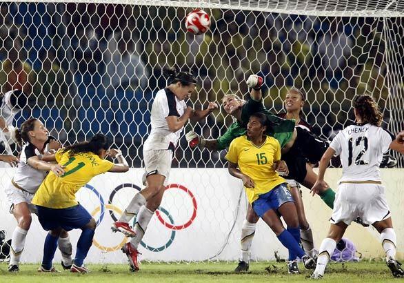 U.S. midfielder Shannon Boxx heads away a corner kick as Brazil threatens to score late in the second half of overtime at the women's Olympic soccer final.
