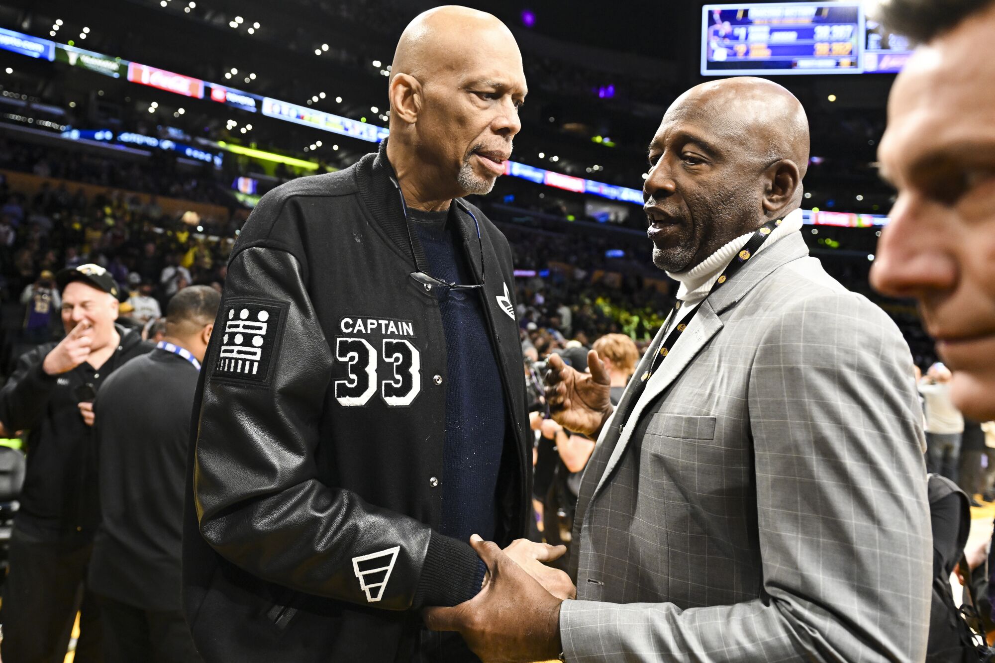 Lakers legends Kareem Abdul-Jabbar, left, and James Worthy talk before the game.