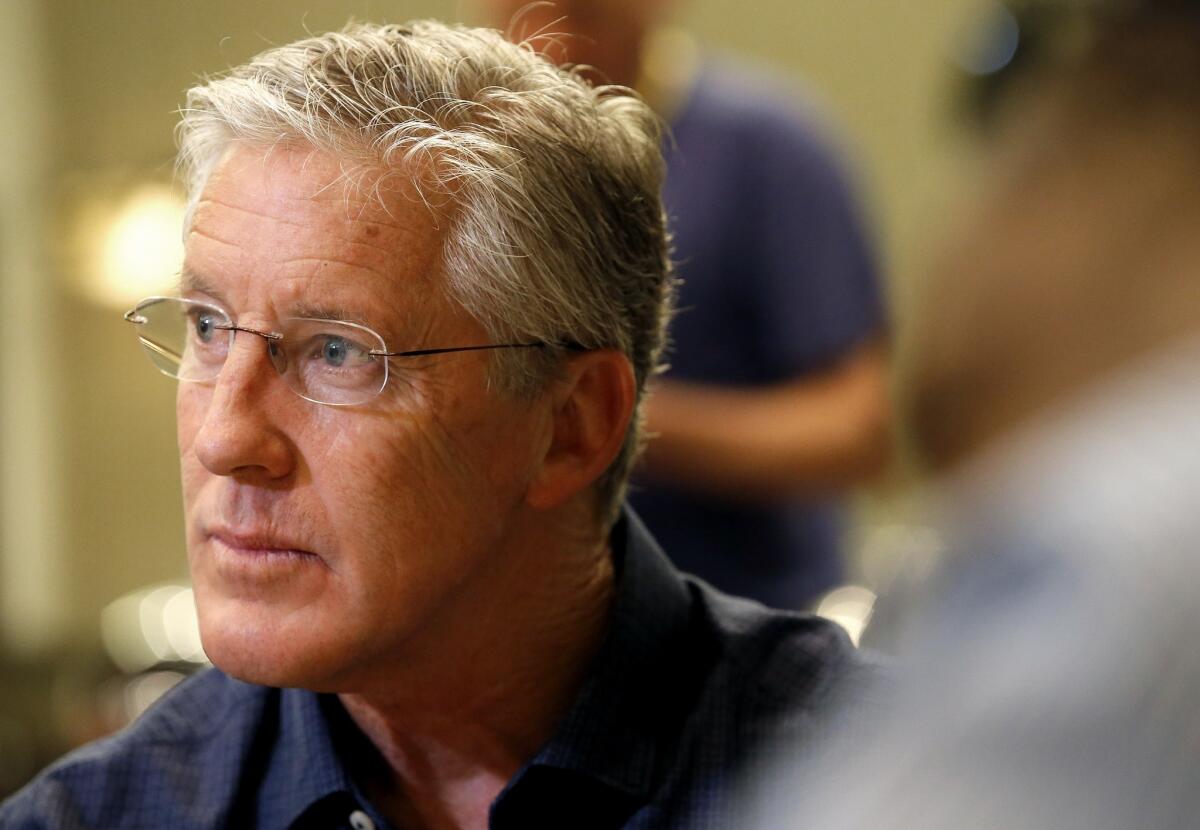 Seattle Seahawks Coach Pete Carroll listens to a question at the NFL owners' meetings Wednesday in Phoenix.