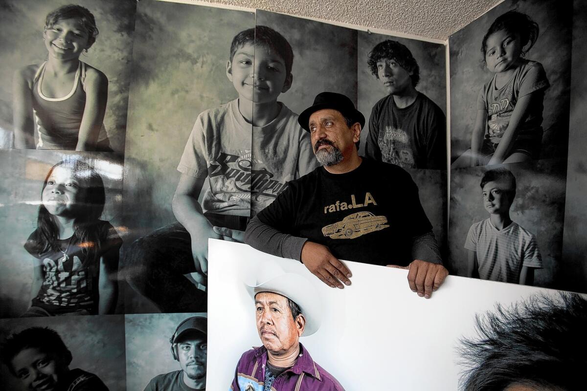 Artist Rafael Cardenas stands among some of his art in his Boyle Heights studio. Over three days last year, Cardenas photographed members of the Eastside community as part of a project for Self Help Graphics' 40th anniversary.