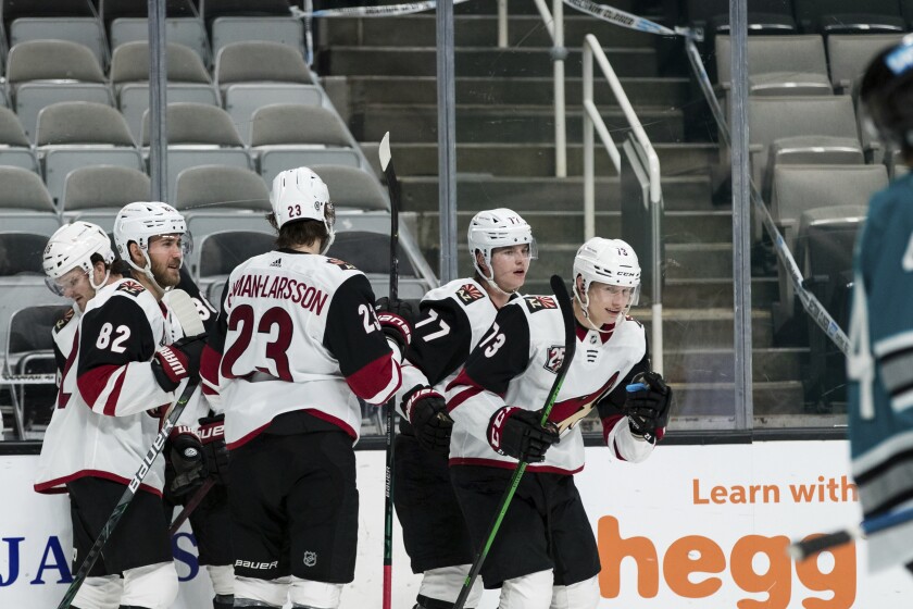 Arizona Coyotes right wing Jan Jenik (73) celebrates with teammates after scoring a goal against the San Jose Sharks during the second period of an NHL hockey game in San Jose, Calif., Saturday, May 8, 2021. (AP Photo/John Hefti)