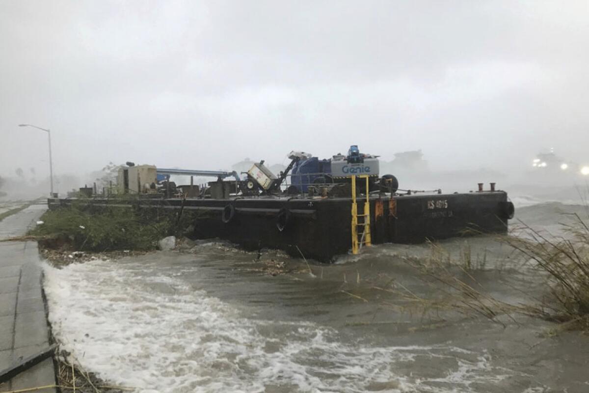A barge runs aground in Pensacola, Fla., on Wednesday.