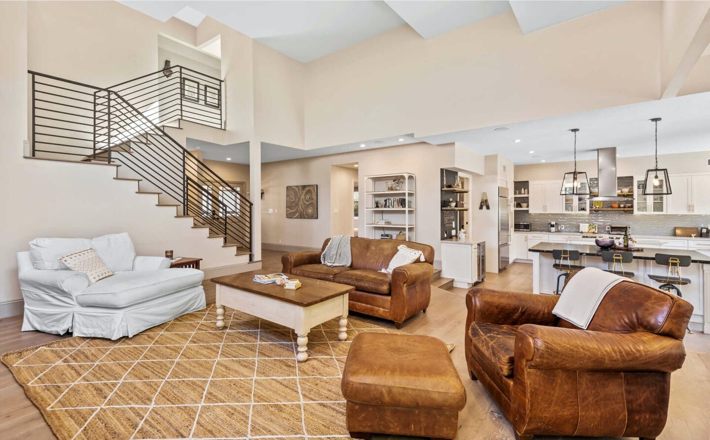 Furnished open floor plan with staircase.