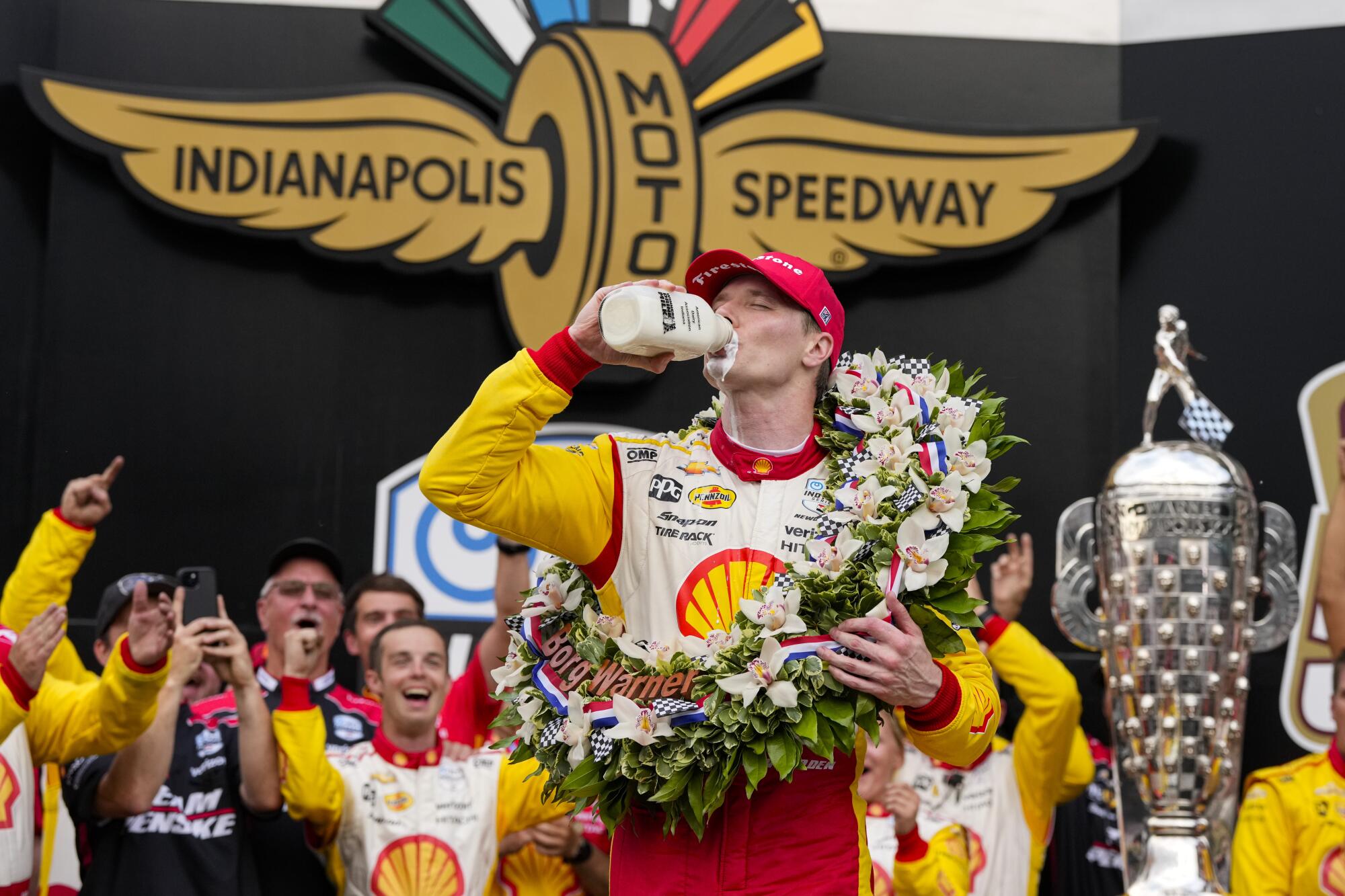 Josef Newgarden takes the traditional celebratory drink of milk after winning the Indy 500 on Sunday.