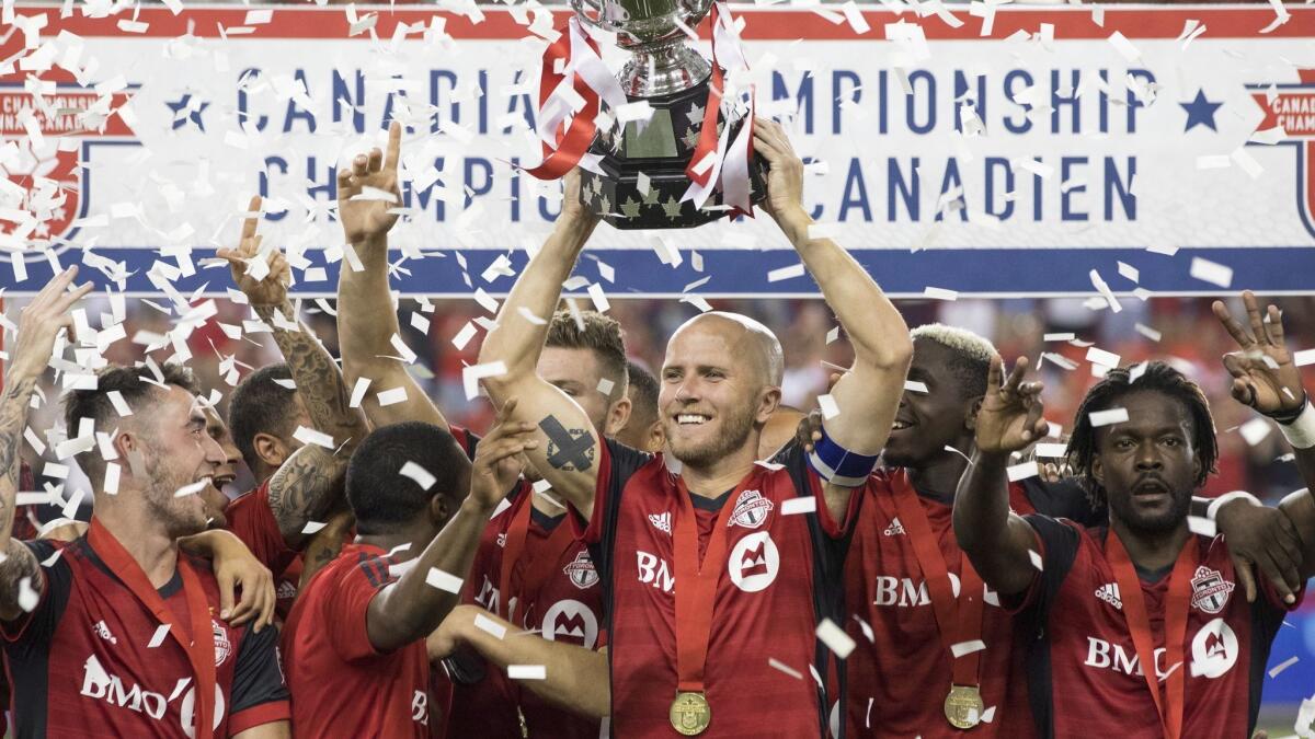 Toronto FC captain Michael Bradley lifts the Voyageurs Cup after a 5-2 victory over the Vancouver Whitecaps on Aug. 15.