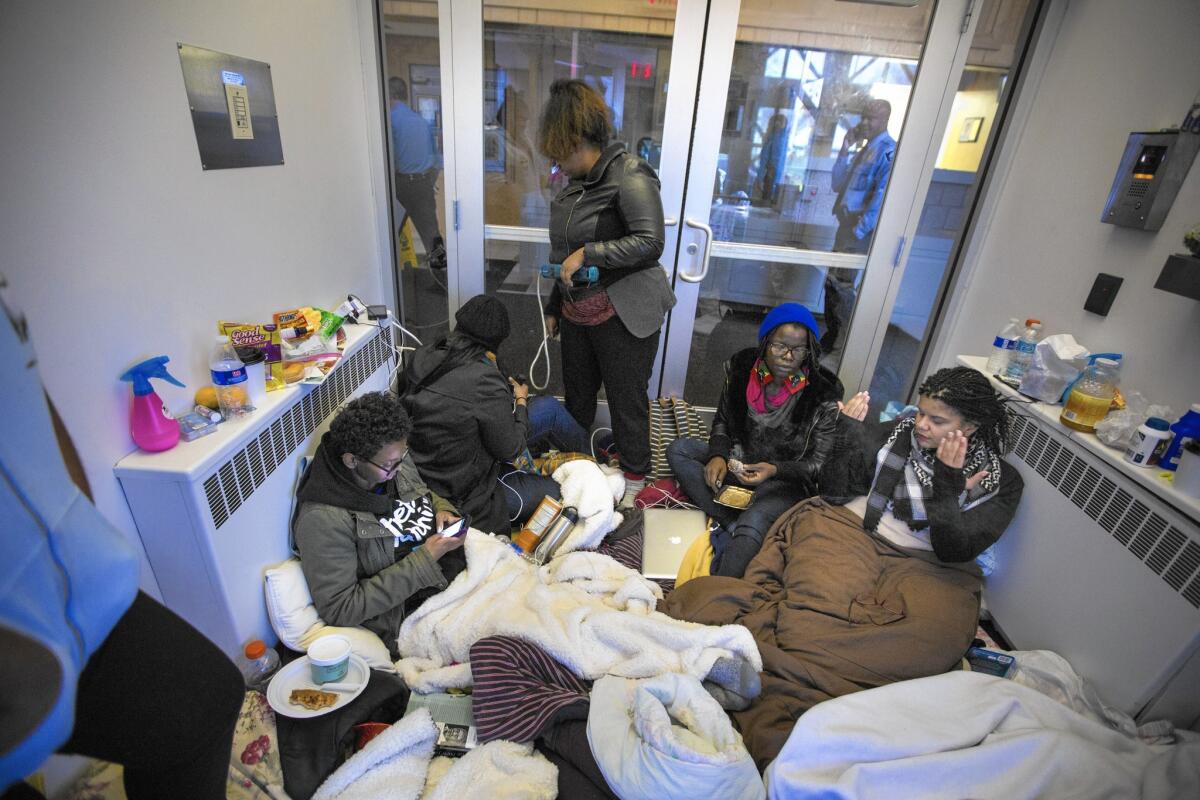 Demonstrators camp out in the lobby of Minneapolis Police Department's 4th precinct station, after officers shot and critically wounded a man over the weekend.