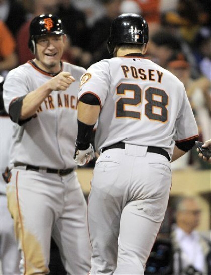 San Francisco Giants' Buster Posey, right, celebrates his two-run home run with Aubrey Huff against the San Diego Padres during the fifth inning of a baseball game in San Diego, Thursday, Sept. 9, 2010. (AP Photo/Chris Carlson)