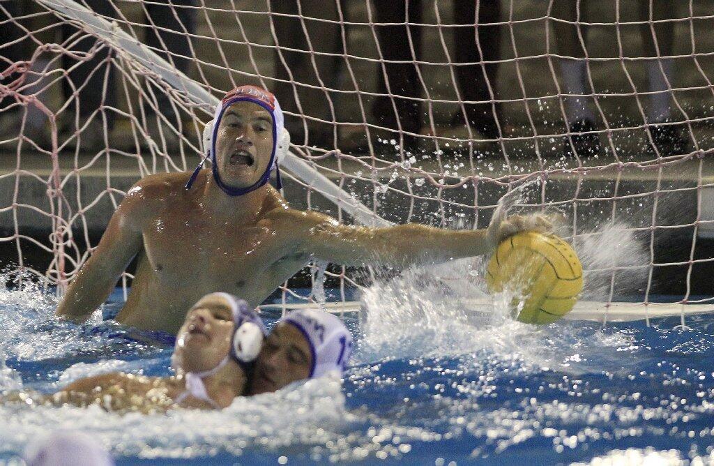 Corona del Mar High goalkeeper Ryan Hamm is unable to stop this shot by Newport Harbor's Clay Davison, not pictured, during the second half in the Battle of the Bay game on Saturday.