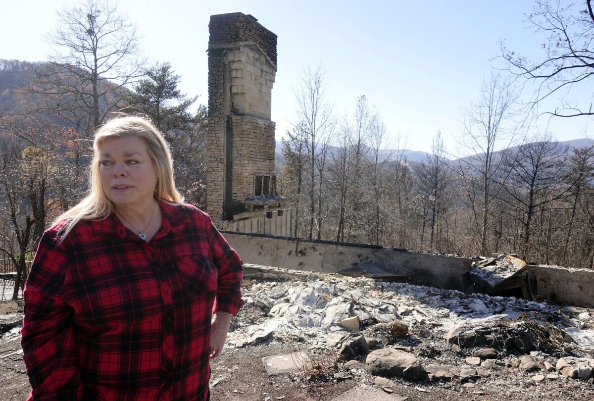 Tammy Sherrod views the remains of her home in the Roaring Fork neighborhood of Gatlinburg, Tenn., which was ravaged by a fast-moving wildfire.