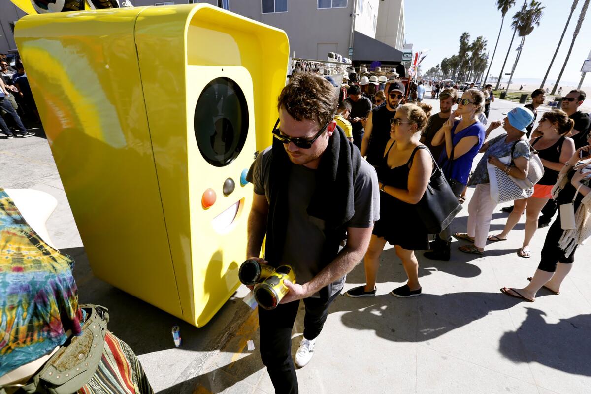People wait in line to collect their Snapchat Spectacles; video camera-enabled sunglasses from Snap Inc., that went on sale in November through a sidewalk vending machine in Venice. About 150 people kept a constant line waiting about three hours for the opportunity to purchase the glasses for $130.