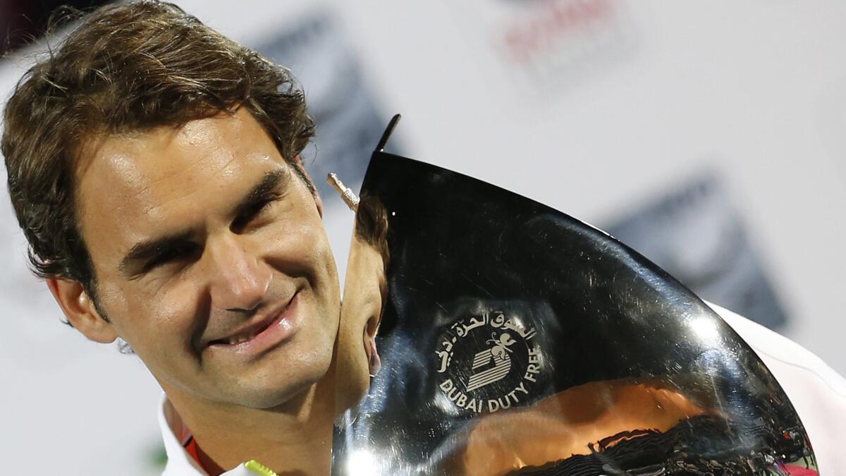 Roger Federer celebrates after defeating Novak Djokovic in the Dubai Championships final on Saturday.