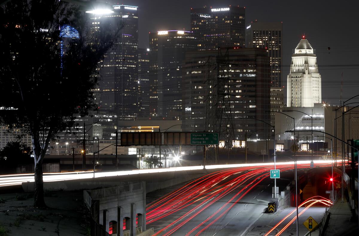 Taillights appear as red streaks in a timed exposure of the interchange of the 101 and 10 freeways at night