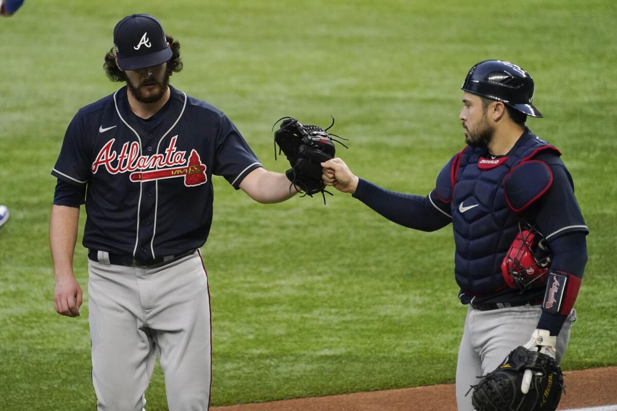 Atlanta Braves starting pitcher Ian Anderson and catcher Travis d'Arnaud celebrate after the fourth inning on Tuesday.