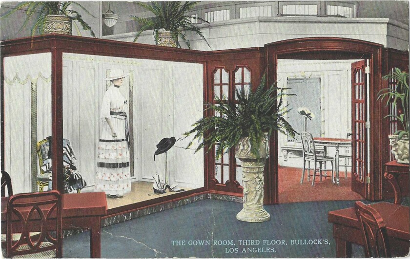 A mannequin in a white gown and hat is seen in an opulent setting on a vintage postcard