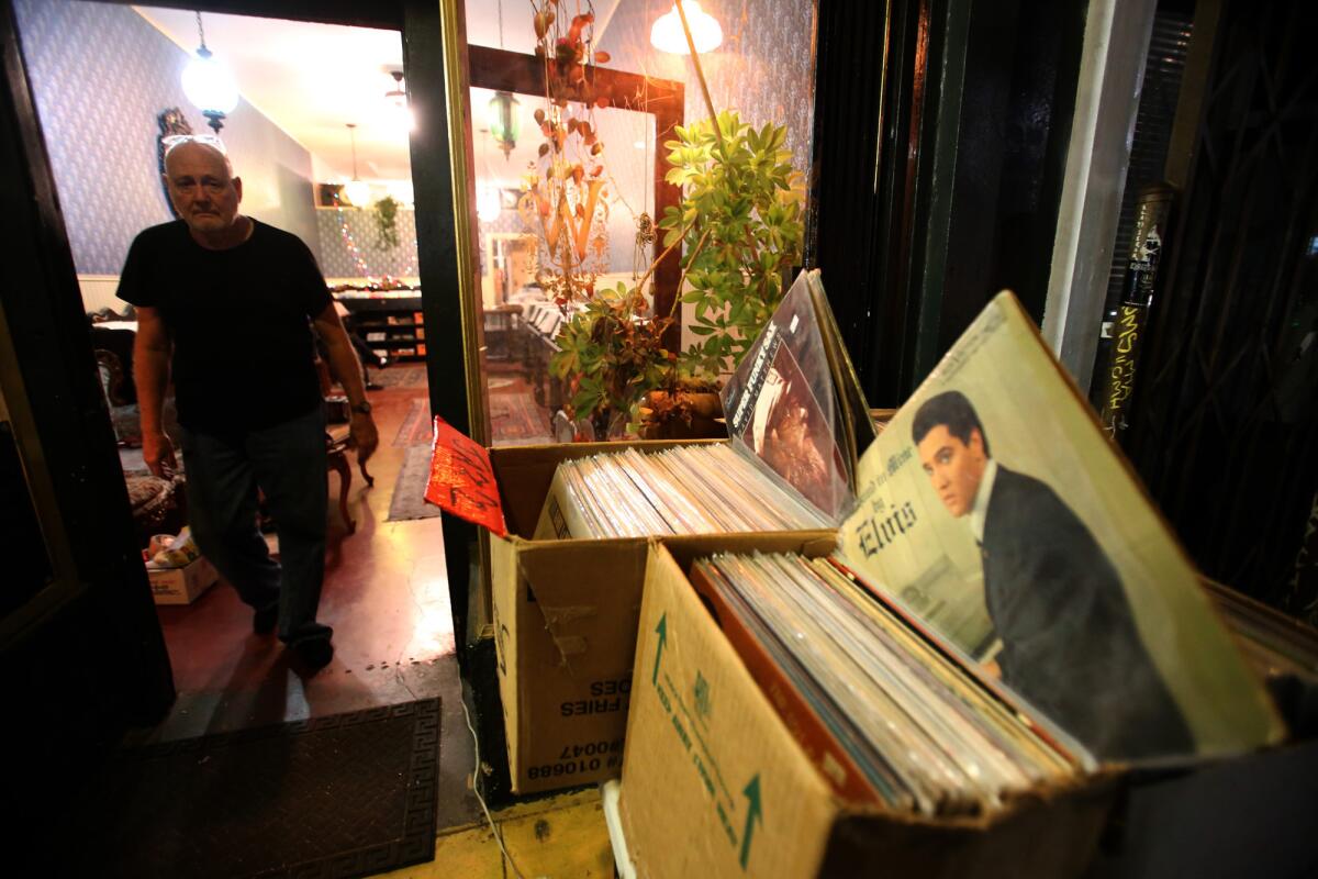 Tom Justice sells vinyl records for his business Mount Washington Vinyl Country Club in front of Wombleton Records in Highland Park.