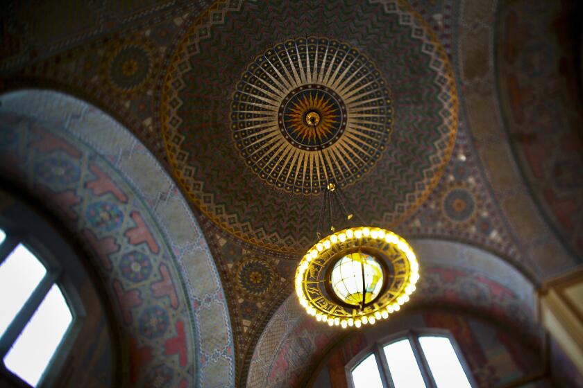 The Los Angeles Central Library downtown has made Fodor's list of the most beautiful libraries to visit. Shown are the multi-colored mosaic-like dome and globe chandelier on the second floor of the library.