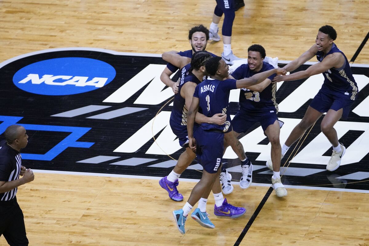 Oral Roberts players celebrate after defeating Florida in the second round of the NCAA tournament on Sunday.