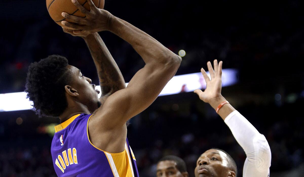 Lakers forward Nick Young pulls up for a shot over portland point guard Damian Lillard in the first half.