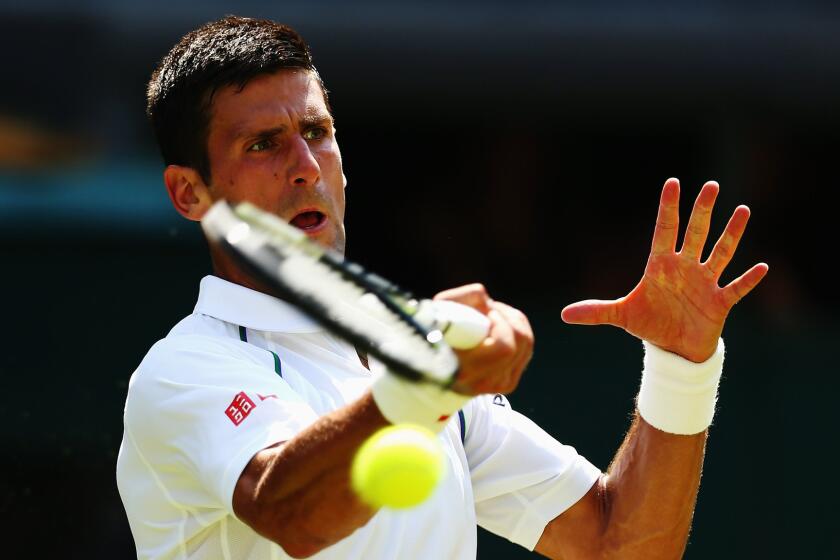 Novak Djokovic plays a forehand during his second-round victory at Wimbledon on Wednesday.