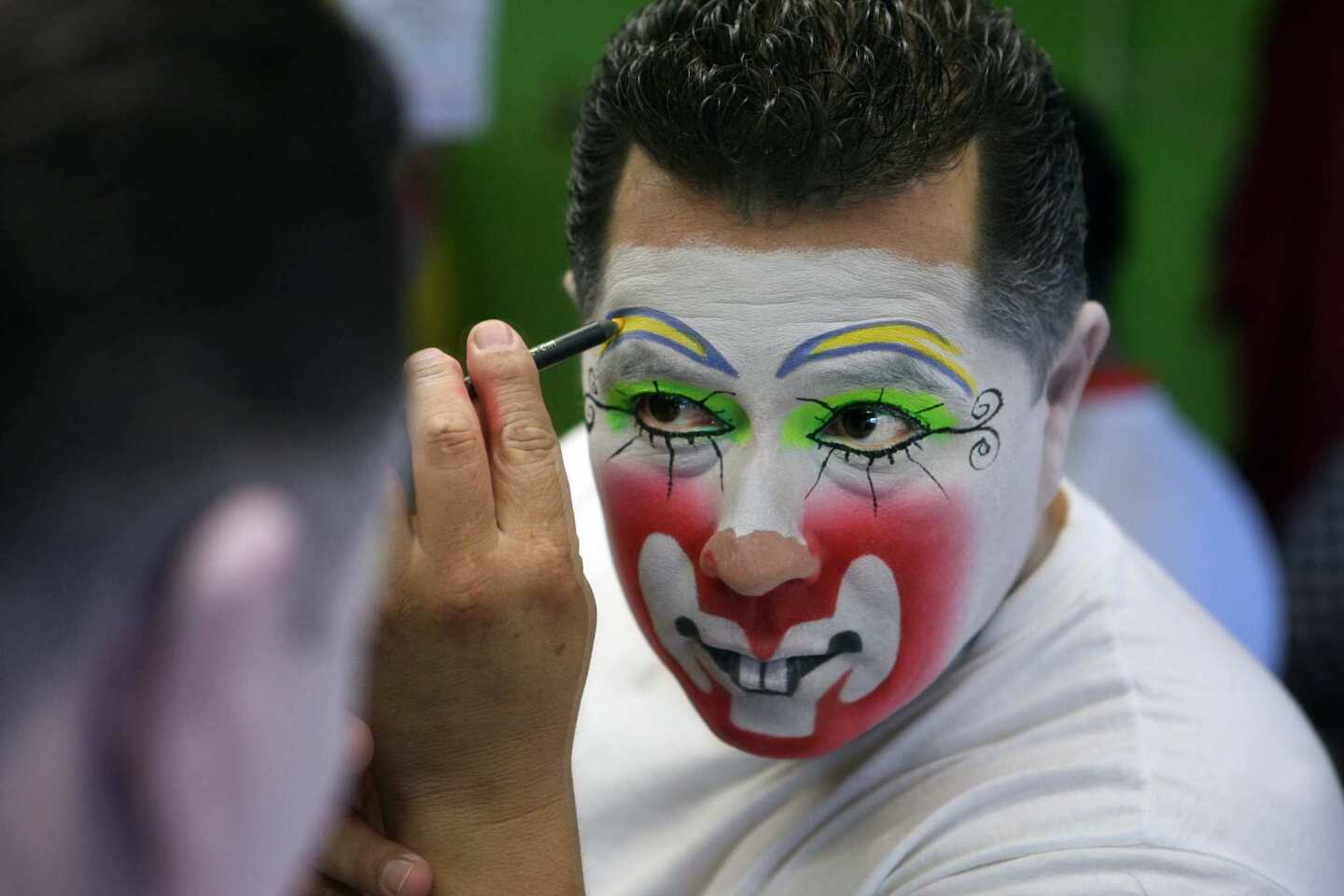 Oscar "Oskarin" Corona puts on his makeup, which takes about an hour, at the Club de Payasos -- the Club of Clowns.