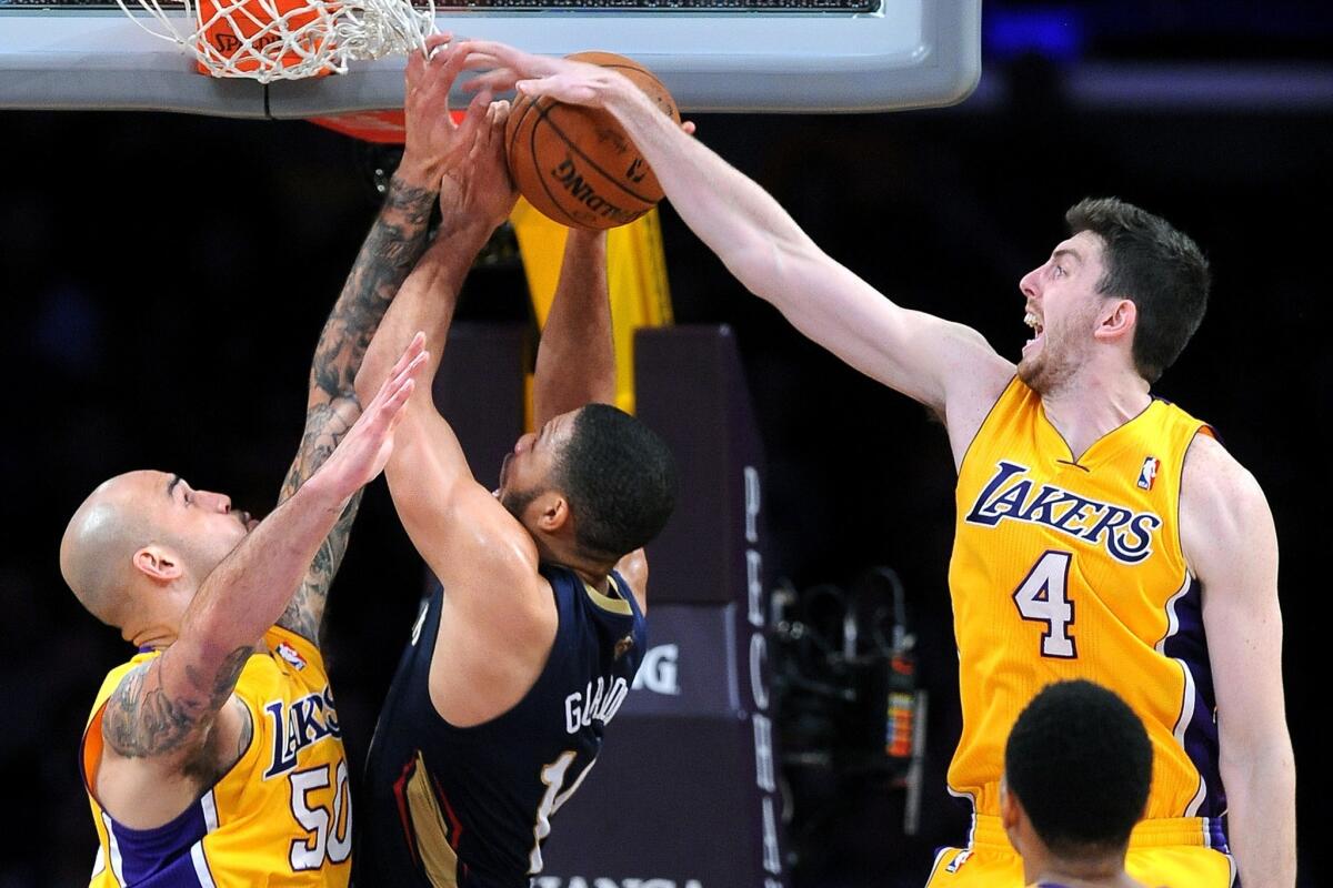 Ryan Kelly, right, gets a hand on New Orleans Pelicans guard Eric Gordon's shot during a game March 4 at Staples Center.