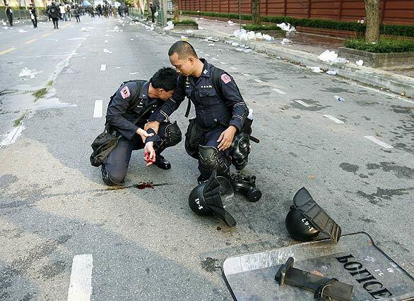 Protest in Thailand - Thai policeman cries in pain