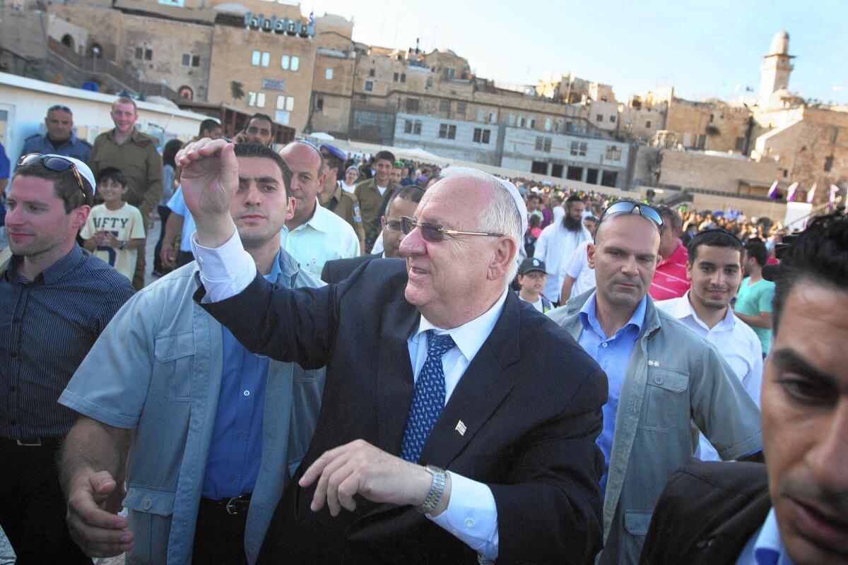 Israel's newly elected president and former Knesset speaker Reuven Rivlin greets supporters at the Western Wall in Jerusalem's Old City.