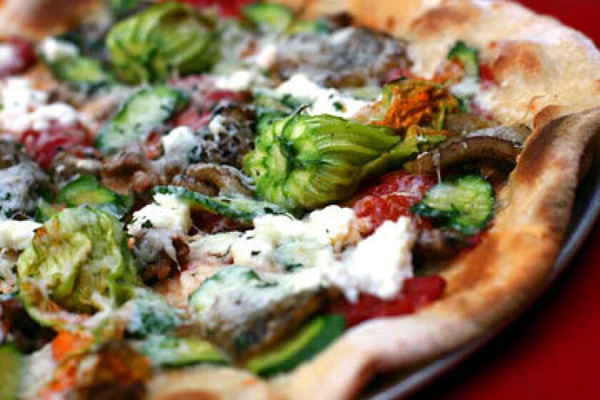 Pizzas are a specialty of the house at Gjelina in Venice. The lamb sausage, zucchini, eggplant, ricotta and pecorino pizza is one of the most popular.