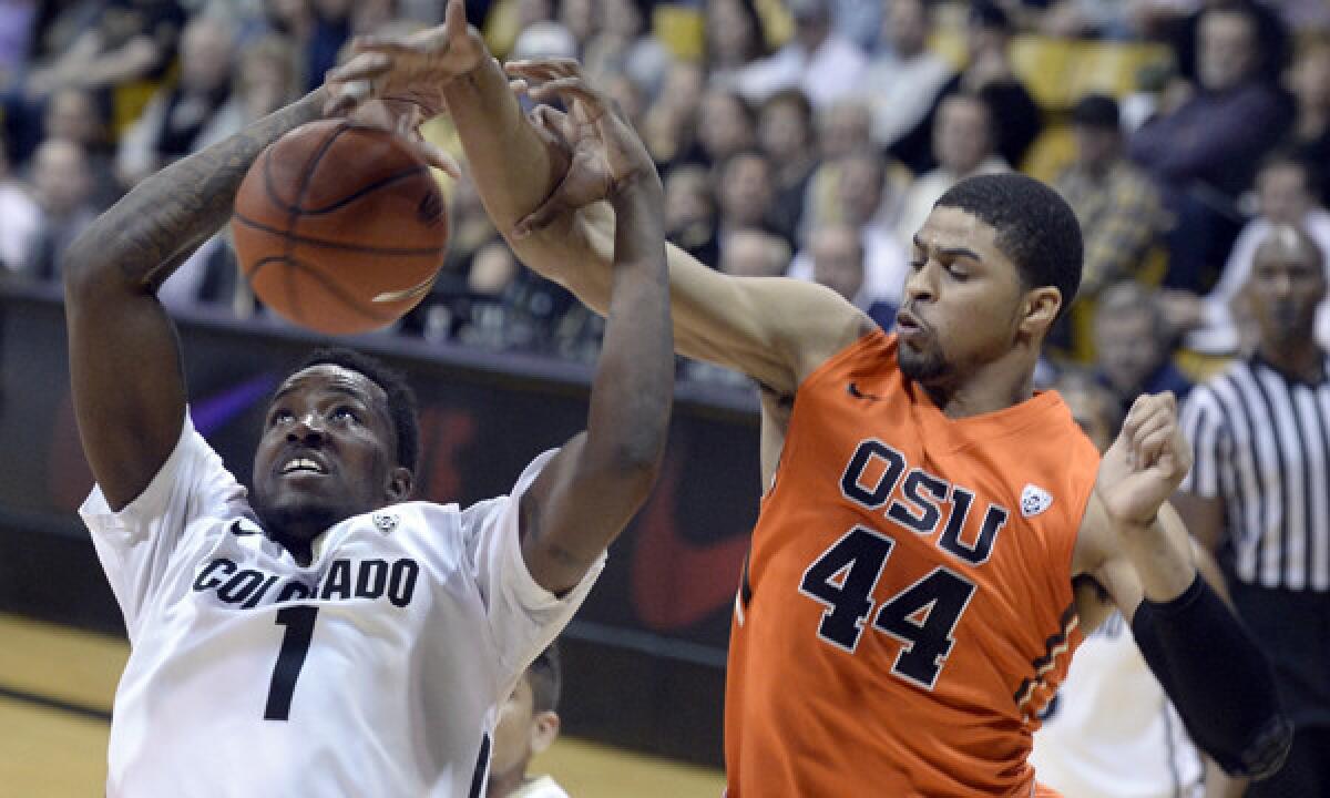 Colorado's Wesley Gordon is fouled by Oregon State's Devon Collier during a the Beavers' 64-58 loss on Jan. 2. USC will play Oregon State on Thursday.