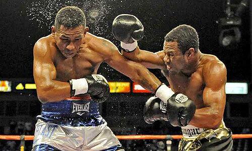 Shane Mosley's blow to the head knocks the sweat off Ricardo Mayorga during their super-welterweight fight Saturday night.