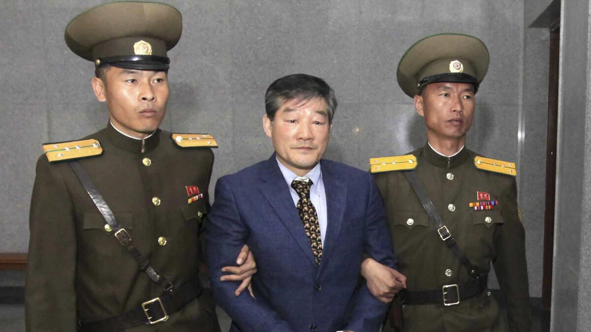 Tong Chul Kim is escorted to his trial in Pyongyang, North Korea, on April 29.