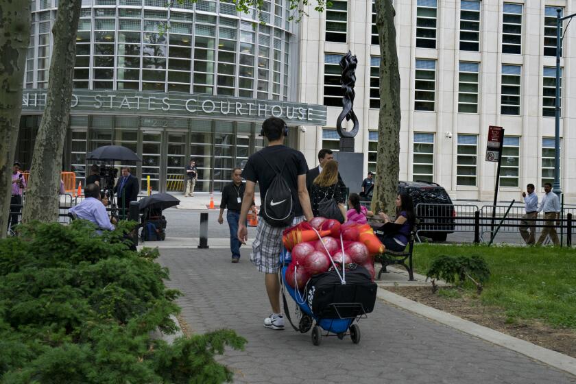 A basket of soccer balls is rolled from a nearby park past a United States Courthouse on May 27 in New York. One of seven officials accused in the FIFA scandal, who were arrested in dawn raids on a luxury hotel in Zurich, was extradited July 16 to the U.S. from Switzerland.