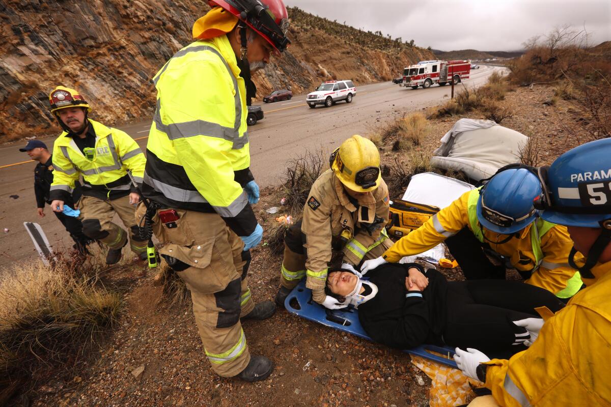Firefighters help a person on a stretcher
