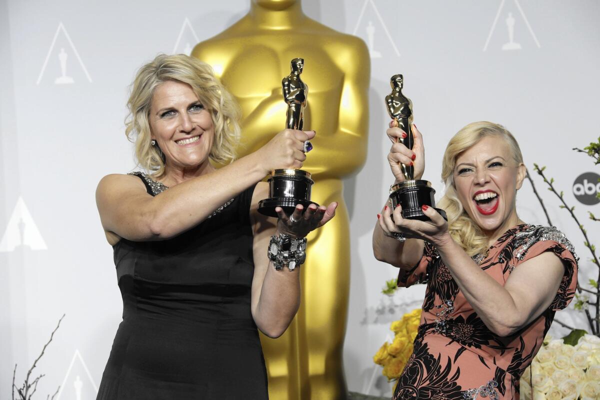 Beverly Dunn, left, and Catherine Martin show off their Oscars for production design for "The Great Gatsby" on March 2, 2014.
