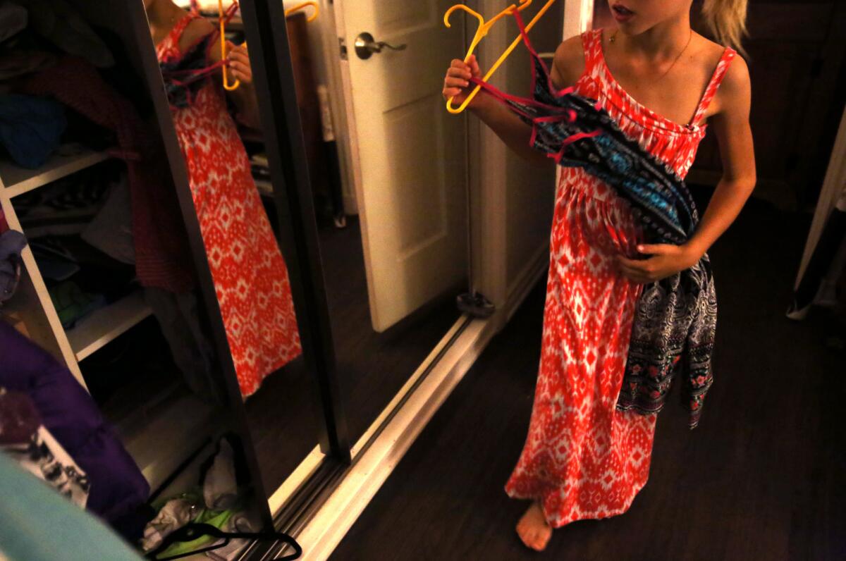 T shows off the first dress she wore at an after-school dance with a disco theme. (Genaro Molina / Los Angeles Times)